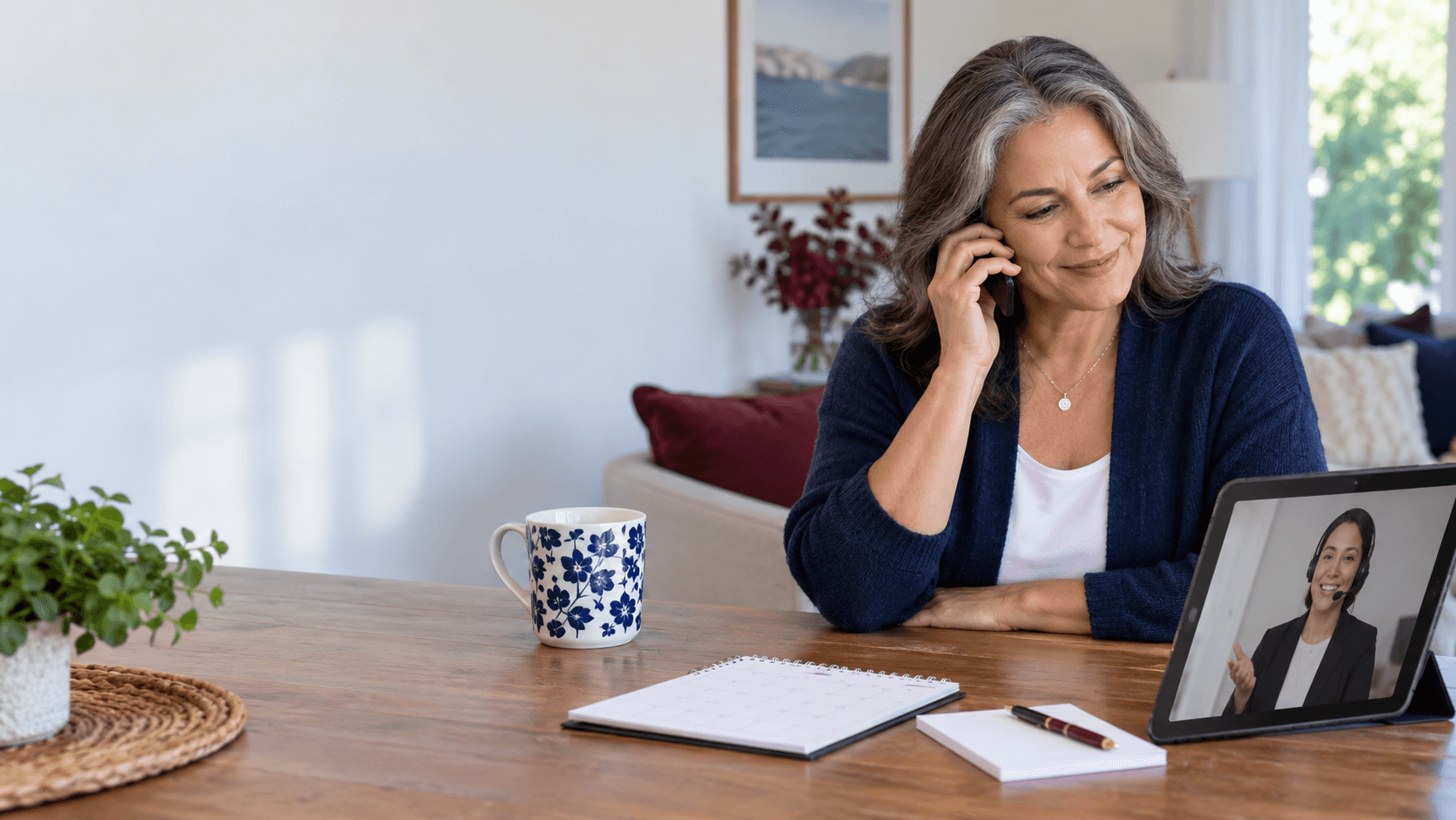 An adult speaks with a coordinator while a blank calendar and video call support a general service-change review.