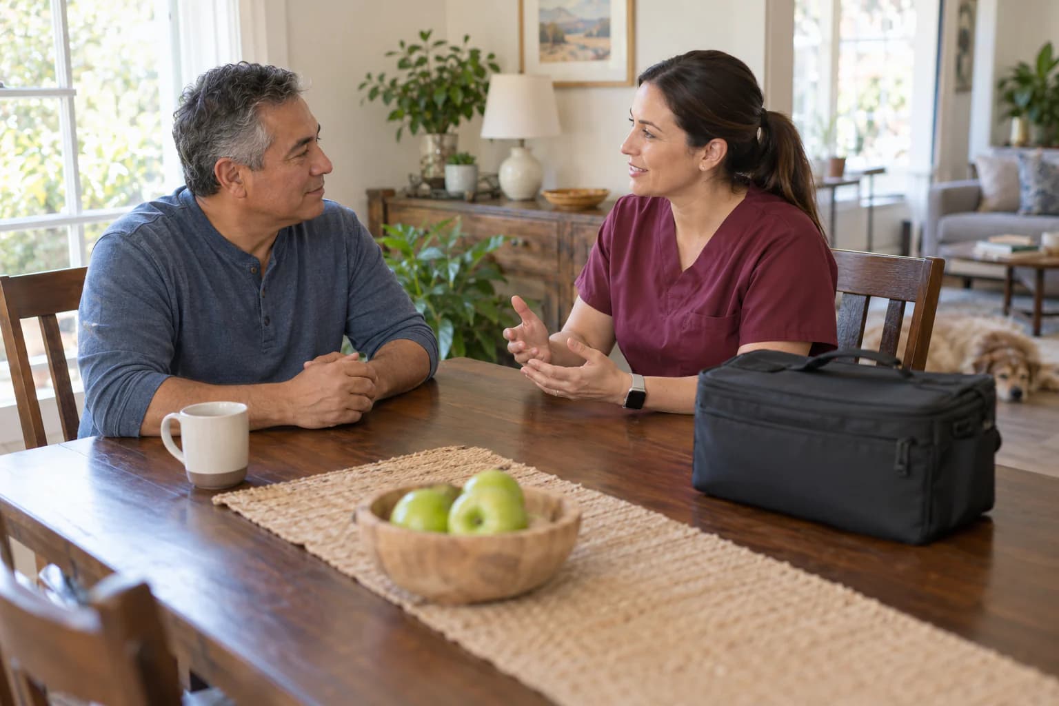 A client and mobile phlebotomist discuss a prepared home collection setting without an invasive procedure.